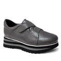 The Django & Juliette Ellore Charcoal Grey Leather Platform Shoe for women features a cushioned, rounded toe, velcro strap, and thick black-and-white striped sole for a stylish and comfortable casual look.