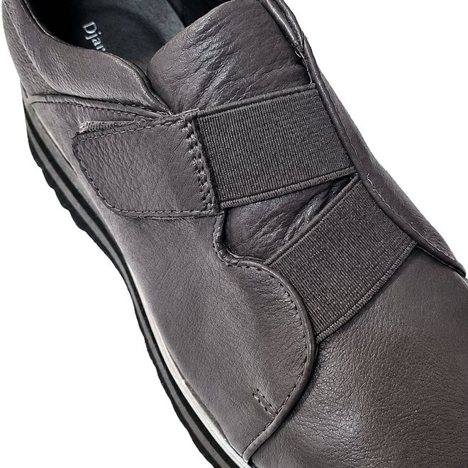 Close-up of the Django & Juliette Ellore Charcoal Grey Leather Platform Shoe for women, featuring elastic bands across the top and a black rubber sole, highlighting its texture and detailed stitching., 51103, 4434754334016, 4434754334023, 4434754334030, 4434754334047, 4434754334054, 4434754334061