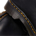 Close-up of Dr Martens 101 UB Black Ambassador 6 Eye Leather Boot, highlighting the thick sole, distinct yellow stitching, and textured black Ambassador leather. The focus is on the soft leather and signature stitching details., 190665693683, 190665693690, 190665693706, 190665693720, 190665693737, 190665693744, 190665693768, 190665693775