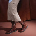 A model wearing a skirt, striped crew socks in beige and brown and Dr Martens Amabssador leather boots in cashew tan. In a walking stance showing the outer foot of the right foot & the inner of the left foot.,
190665662757,
190665662764,
190665662788,
190665662795,