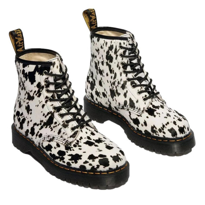 Dr Martens 1460 Bex Dalmatian Hair On Leather Lace Up Boot features a white hair-on leather upper with Dalmatian spots, black soles, yellow stitching on a Goodyear welted sole, and a black-and-yellow branded heel loop., 190665780307, 190665780314, 190665780321, 190665780345, 190665780352, 51690