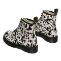 The Dr Martens 1460 Bex Dalmatian Hair On Leather Lace Up Boot features black and white cow print hair-on leather, thick black soles, yellow stitching, and Goodyear welted construction for lasting durability., 190665780307, 190665780314, 190665780321, 190665780345, 190665780352, 51690