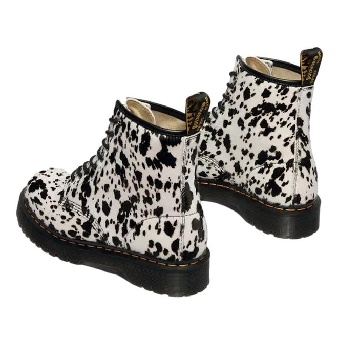 The Dr Martens 1460 Bex Dalmatian Hair On Leather Lace Up Boot features black and white cow print hair-on leather, thick black soles, yellow stitching, and Goodyear welted construction for lasting durability., 190665780307, 190665780314, 190665780321, 190665780345, 190665780352, 51690