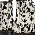 Close-up of the Dr Martens 1460 Bex Dalmatian Hair On Leather Lace Up Boot, showcasing its black and white Dalmatian print, yellow stitching, and textured Hair-On leather on the back., 190665780307, 190665780314, 190665780321, 190665780345, 190665780352, 51690