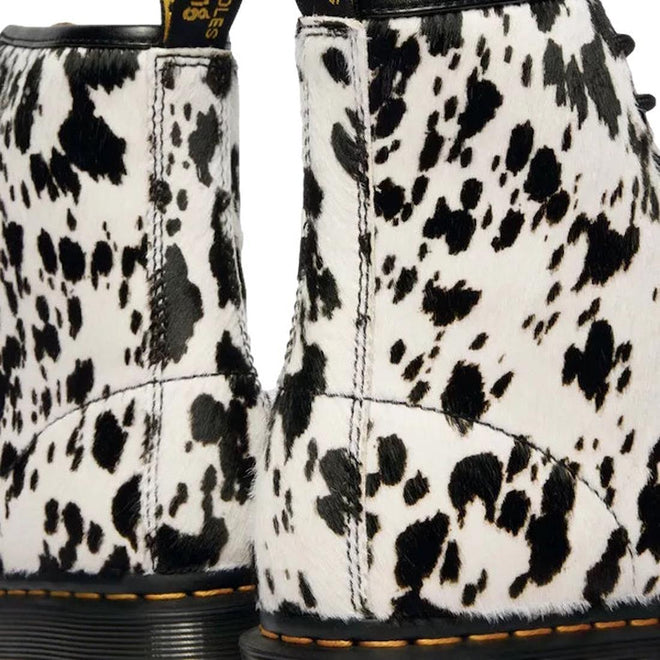 Close-up of the Dr Martens 1460 Bex Dalmatian Hair On Leather Lace Up Boot, showcasing its black and white Dalmatian print, yellow stitching, and textured Hair-On leather on the back., 190665780307, 190665780314, 190665780321, 190665780345, 190665780352, 51690