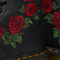 Close-up of the Dr Martens 1460 Vonda Red Roses Softy T Leather Boot, showcasing bright red embroidered roses with green leaves, signature yellow stitching on the sole, and classic AirWair Bouncing Soles., 190665206036, 190665206043, 190665206050, 190665206074, 190665206081, 190665206098