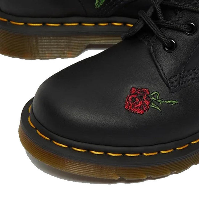 Close-up of Dr. Martens 1460 Vonda Red Roses Softy T Leather Boot, showing yellow stitching, AirWair Bouncing Soles, and a small red rose with green stem embroidered on the toe., 190665206036, 190665206043, 190665206050, 190665206074, 190665206081, 190665206098