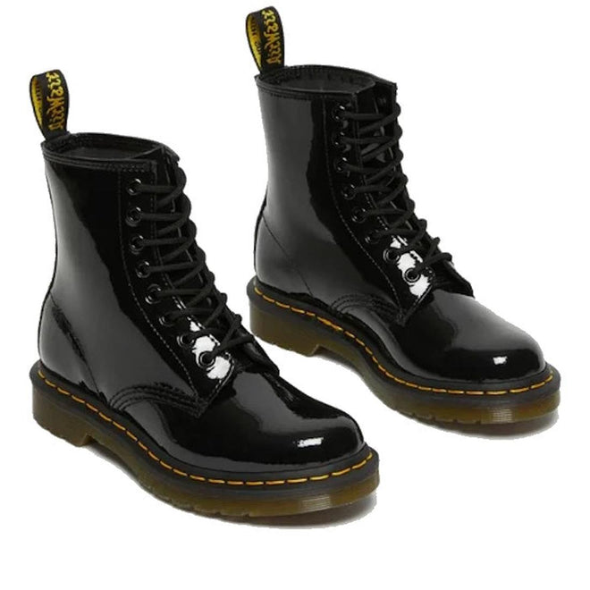 Pair of Dr Martens Patenet black leather boots with yellow stitching on a white background.,
883985035249,
883985035256,
883985035270,