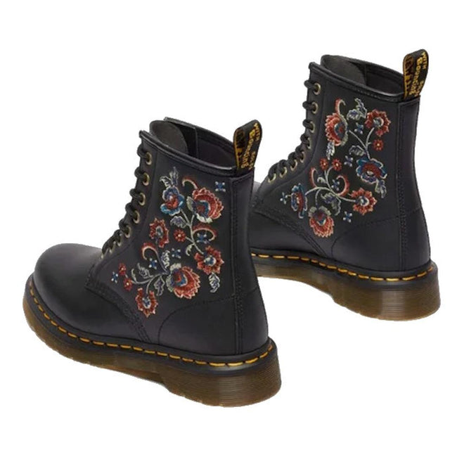 A pair of black Dr. Martens 1460 Vonda TF Tavern Floral Genix Nappa Leather boots with floral embroidery, yellow Goodyear-welted stitching, and back pull tabs., 47991, 190665742619, 190665742626, 190665742633, 190665742657, 47996, 47997