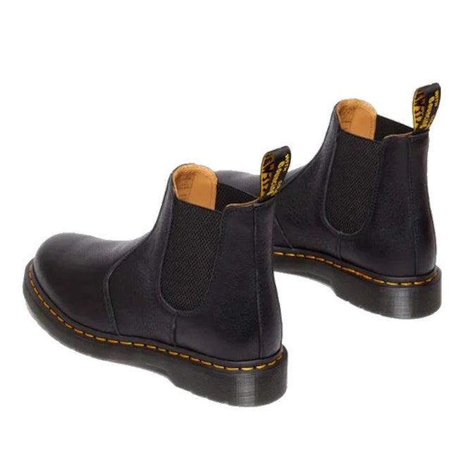 The Dr Martens 2976 Ambassador Black Leather Chelsea Boot features durable black Ambassador leather, yellow stitching, elastic side panels, Goodyear-welted soles, and pull tabs at the back, shown on a white background., 50056, 50057, 50059, 190665663303, 190665663310, 190665663327, 50067, 50068