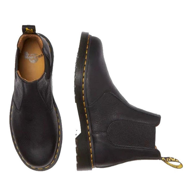 The Dr Martens 2976 Ambassador Black Leather Chelsea Boot, featuring Goodyear-welted construction, yellow stitching, and heel loops, is shown in side and top views on a white background., 50056, 50057, 50059, 190665663303, 190665663310, 190665663327, 50067, 50068