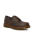 The Dr Martens 8053 Crazy Horse Dark Brown Leather 5 Eye shoe features classic yellow stitching, a black padded collar, and a chunky translucent air-cushioned sole for comfort and timeless unisex style.