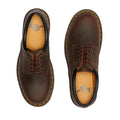 A pair of Dr Martens 8053 Crazy Horse Dark Brown Leather 5 Eye shoes with yellow stitching and air-cushioned soles seen from above. The left shoe has plain brown laces; the right has brown and red striped laces., 52072, 52073, 800090801651, 800090801675, 800090801682, 800090801699, 800090801712