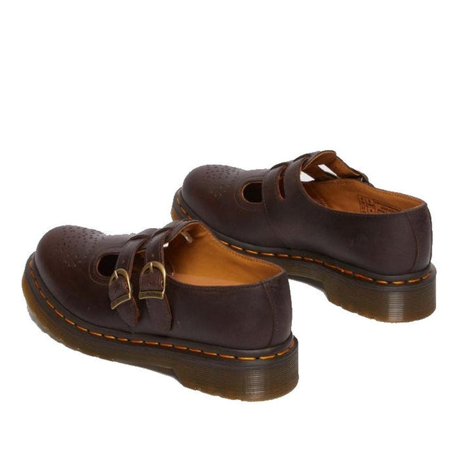 The Dr. Martens 8065 2 Strap Mary Jane Shoe in Crazy Horse Brown features a dual buckle design, perforated toe details, thick soles, and the brand’s signature yellow stitching., 190665588941, 190665588958, 190665588965, 190665588972, 13164654654, 190665588996, 190665589009, 190665589016