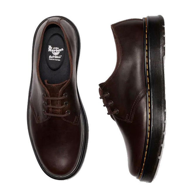 The Dr Martens Brookline Lo Dark Brown Crazy Horse Leather Shoe features brown leather uppers, black soles with yellow stitching, and brown laces, shown from the top and side., 52062, 52063, 52064, 190665753912, 190665753936, 190665753943, 190665753950, 52069, 52070, 52071