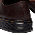 Close-up of the heel of a Dr Martens Brookline Lo Dark Brown Crazy Horse Leather Shoe, highlighting visible stitching and a black rubber sole with yellow stitching detail., 52062, 52063, 52064, 190665753912, 190665753936, 190665753943, 190665753950, 52069, 52070, 52071