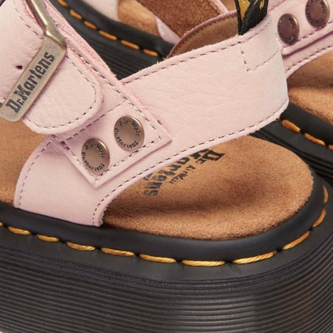 Close-up of rivits on the heel strap on pink Dr. Martens sandals with brown soles and visible brand logo.,
190665714630,
190665714647,
190665714661,