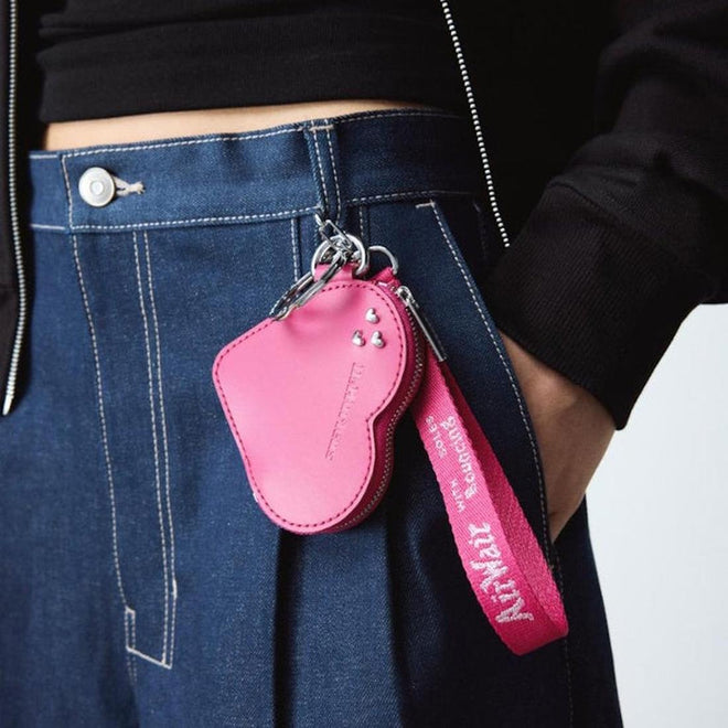 Pink Dr Martens purse charm heart shaped leather keychain with strap attached to a person's pocket.,
190665739800,