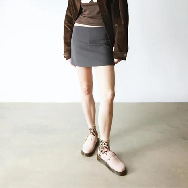 Person wearing a brown jacket, gray skirt, and Dr Martens Jorge pink Scuff mules with leopard print socjks on a plain background.,
190665705478,
190665705485,
190665705492,
190665705515,
190665705522,