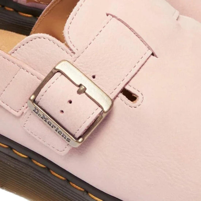 Close-up detal of a pink Dr Martens  Jorge Sandals Mules with a gold buckle, featuring the Dr. Martens logo.,
190665705478,
190665705485,
190665705492,
190665705515,
190665705522,