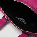 Close-up of a pink bag with a visible brand logo on a white background,
190665739527,