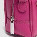 Close-up of a pink backpack with a zipper and visible brand name on a light gray background.,
190665739527,