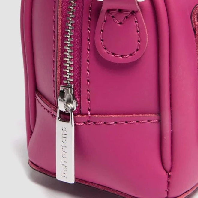 Close-up of a pink backpack with a zipper and visible brand name on a light gray background.,
190665739527,