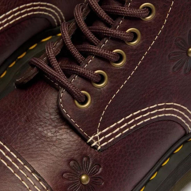 Close-up of Dr Martens Sinclair Flower Dark Brown Grizzly Leather Boot featuring brown laces, brass eyelets, white decorative stitching, embossed floral patterns, and yellow stitching on the platform Quad sole., 51903, 51904, 190665777116, 190665777123, 190665777147, 51909, 51910
