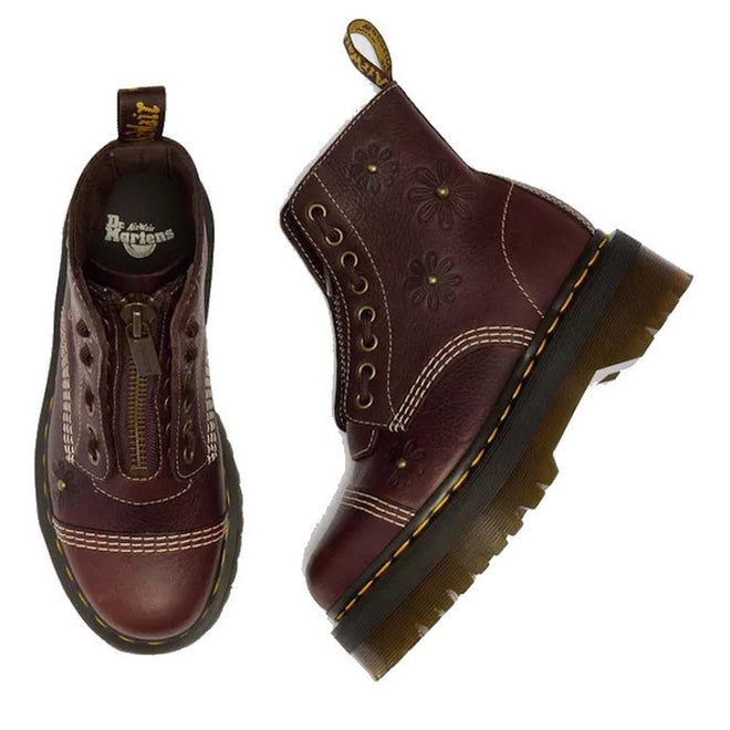 A pair of Dr Martens Sinclair Flower Dark Brown Grizzly Leather Boots featuring floral embossing, yellow stitching, thick Quad platform soles, side zippers, and branded heel loops. One boot is shown from above, the other from the side., 51903, 51904, 190665777116, 190665777123, 190665777147, 51909, 51910