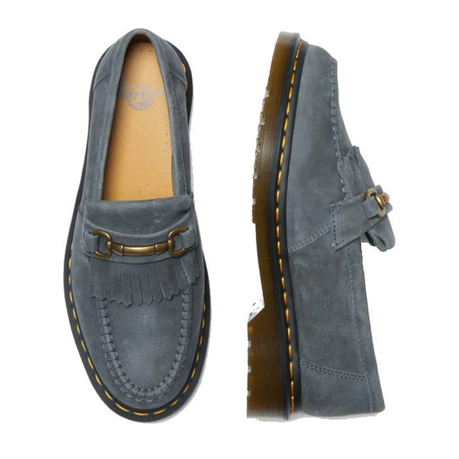 Dr Martens Adrian Snaffle Loafer Washed Denim Tumbled Nubuck shoes feature a decorative metal bit, fringe detail, visible yellow stitching, and a thick translucent sole, shown from top and side views.