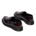 Dr Martens Temara Cherry Red Arcadia Leather Loafers with glossy finish and black rubber soles, Goodyear-welted, shown at an angle on a white background to highlight the back and side views., 190665747560, 190665747577, 190665747591, 52060, 52061
