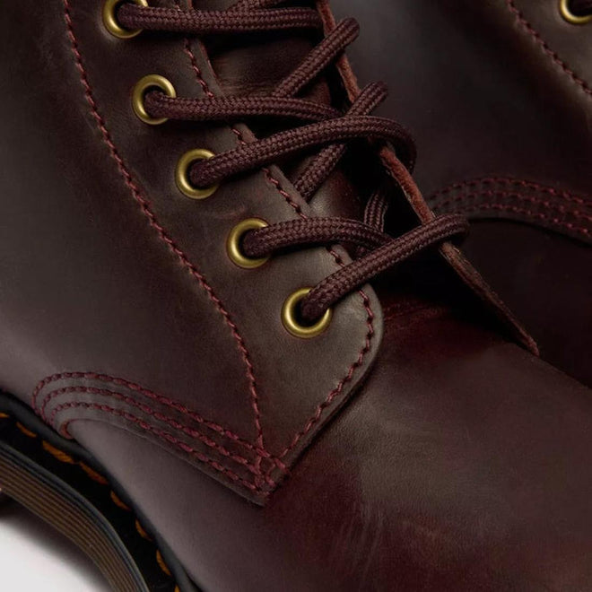 Close-up of Dr Martens 1460 Cherry Red Crazy Horse Waxy Leather 8 Eye Boot, featuring brown laces in brass eyelets, detailed stitching, Goodyear Welted construction, and part of the durable rubber sole., 190665786835, 190665786842, 190665786859, 190665786873, 190665786880, 190665786897, 190665786910, 50000, 50001, 50002