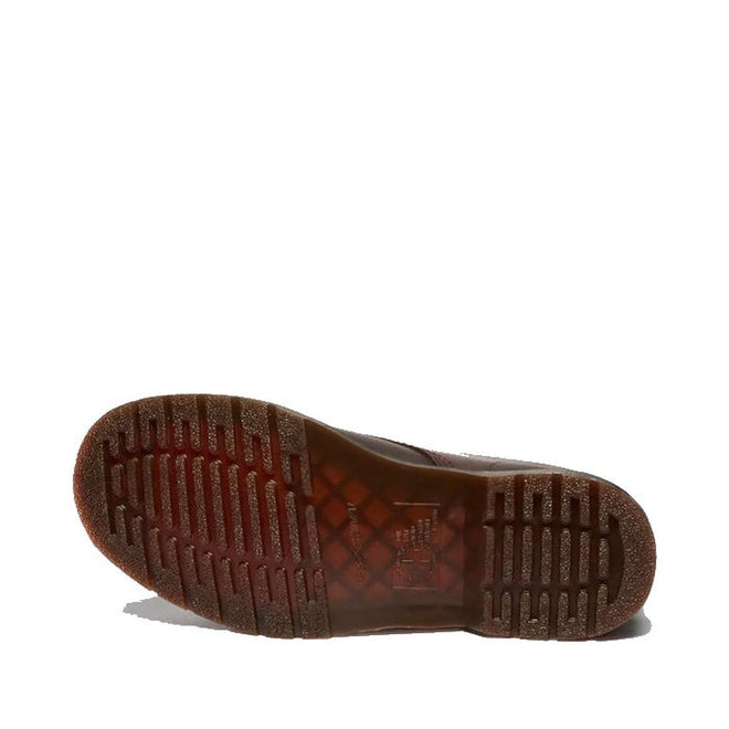 The image shows the sole of a Dr Martens 1460 Cherry Red Crazy Horse Waxy Leather 8 Eye Boot, featuring a textured, grooved tread and slightly transparent rubber material, laying on its side against a white background., 190665786835, 190665786842, 190665786859, 190665786873, 190665786880, 190665786897, 190665786910, 50000, 50001, 50002