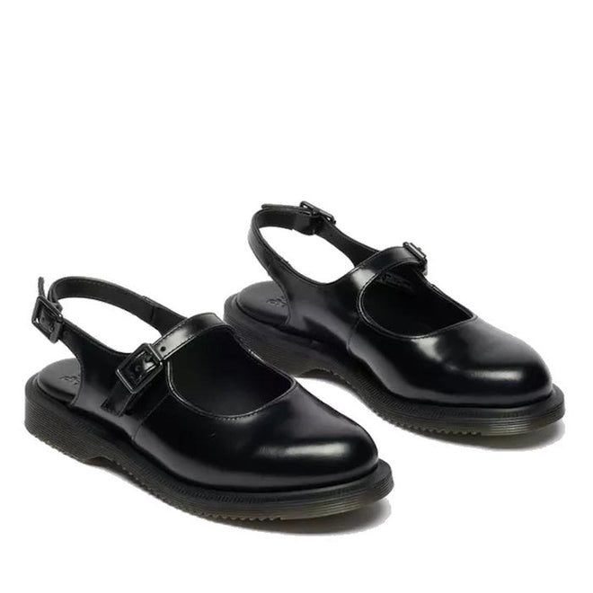 The Dr. Martens Madaline Black Smooth Women's Slingback Mary Jane Shoes feature shiny black polished leather, closed rounded toes, thick rubber soles, and adjustable buckle straps over the instep and heel.