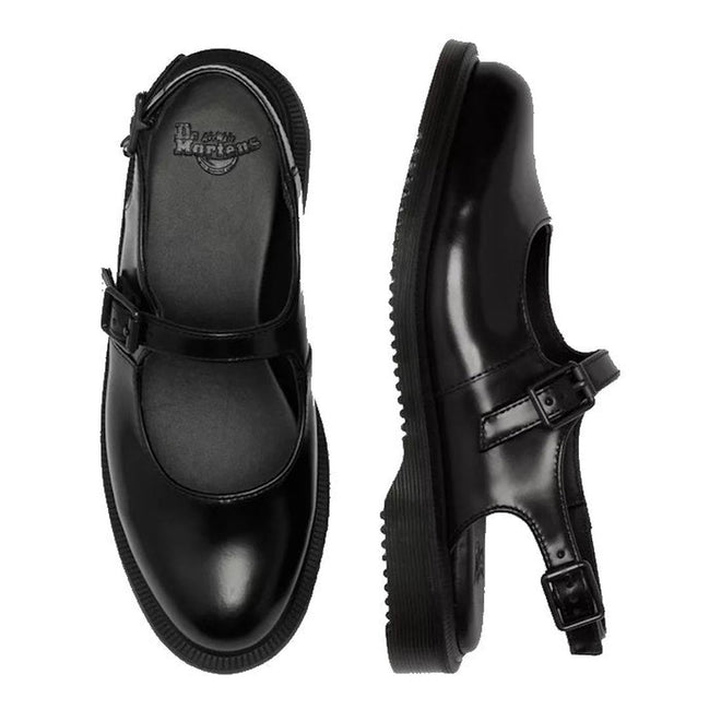 The Dr. Martens Madaline Black Smooth Women's Slingback Mary Jane Shoes feature shiny black leather, buckle straps, thick soles, rounded toes, and the iconic Dr. Martens logo on the insole, shown from top and side views.