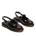 A pair of Dr Martens Madaline Cherry Red Arcadia Women’s Slingback Mary Jane shoes with open heels, gold buckles, chunky black soles with yellow stitching, made from Polished Smooth leather and Goodyear welted.
