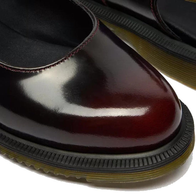 Close-up of Dr Martens Madaline Cherry Red Arcadia Women's Slingback Mary Jane Shoes with polished smooth leather, rounded toes, black cushioned insoles, contrasting stitching, and thick black soles with yellow-brown Goodyear welted edges.