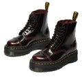 The Dr. Martens Sinclair Cherry Red Arcadia Leather Platform Boot features high-shine leather, yellow stitching, black laces, a thick black sole, and a yellow-branded pull tab at the back., 51252, 190665278637, 190665278644, 190665278668, 51256