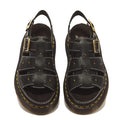 Dr Martens Wrenlie Flower Open Toe Black Milled Nappa Quad Sandals in black leather featuring gold-tone buckles, stud detailing, and yellow stitching along the Goodyear welted platform soles.