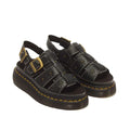 Dr Martens Wrenlie Flower Open Toe Black Milled Nappa Quad Sandal in milled Nappa leather, featuring brass buckles, a platform sole, and yellow stitching.