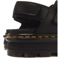 Close-up of the heel area of a Dr Martens Zebzag Black Pisa Leather 3 Strap Sandal, featuring black Pisa leather, yellow stitching along the air-cushioned sole, and a thick, grooved rubber platform.