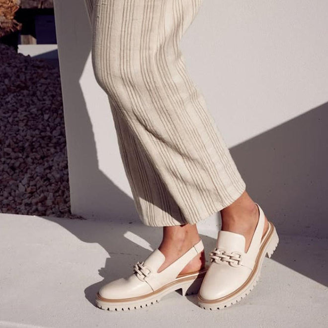 Person wearing beige loafers and light-colored pants on a neutral background,
9321191121352,
9321191121369,
9321191121376,
9321191121383,
9321191121390,