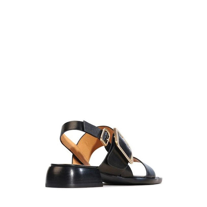 The EOS Ikam Women's Black Leather Low Heeled Sandal with back strap, tan interior, wide strap, and large gold buckle is displayed from a rear angle against a white background., 9321191304915, 9321191304922, 9321191304939, 9321191304946, 9321191304953
