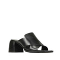 The EOS Iso Black Leather Heeled Sandal features black cashmere leather, wide crisscross straps, an open toe, and a chunky mid-height block heel, shown against a plain white background.