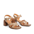 The EOS Isoken Desert Women's Leather Heeled Sandal features beige cashmere leather, strappy block heels, and an ankle strap with a gold buckle, shown on a white background., 9321191307015, 9321191307022, 9321191307039, 9321191307046, 9321191307053