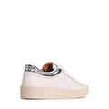 The EOS Jolie Bone Beige Women's Leather Trainer features white leather, a cream sole, metallic silver heel patch, and side zip. Shown from the rear side on a white background, these sneakers blend comfort and style for everyday wear., 47242, 9321191308203, 9321191308210, 9321191308227, 9321191308234, 9321191308241, 47248