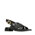 The EOS Laticia Black Leather Sandal features black woven leather straps, a gold buckle on the ankle back strap, and a mini block heel. This chic slingback sandal is shown against a white background.