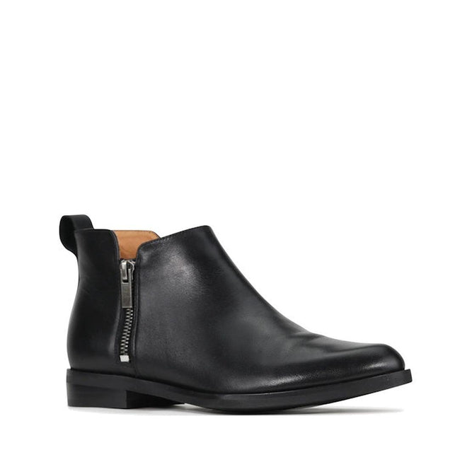The EOS Zarina Black Leather Ankle Boot Double Zip features sleek black leather, double side zippers, a low stacked heel, pull tab at the back, and a slightly pointed toe for timeless minimalist style.