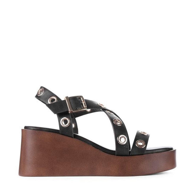 The Los Cabos Lagos Black Women's Wedge Heel Sandal features black straps with silver grommets, a buckle, and a thick brown wedge heel platform, displayed in side profile on a white background., 9321191309392, 9321191309408, 9321191309415, 9321191309422, 9321191309439, 46996