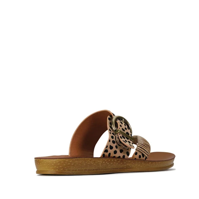Introducing the Los Carbos Bria Cheetah Beige Black Light Flexible Sandal Jandal—a single slip-on sandal with a brown sole and two wide straps in a tan and black spotted pattern, accented by a large circular buckle. Inspired by the Bria collection, this stylish jandal offers a chic alternative to traditional women’s thong sandals and summer flip flops.